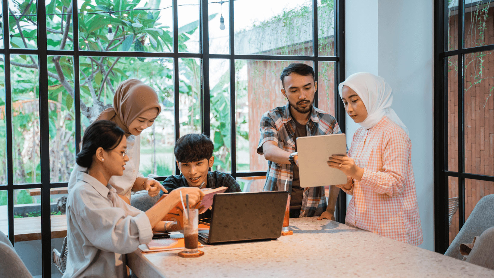 Group of asian students using technology to learn